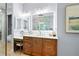 A modern bathroom boasts a large vanity, makeup station, updated mirrors and modern lighting at 11 York Trce, Cartersville, GA 30121