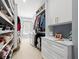 Large walk-in closet with custom built-ins for shoes and clothing, plus a window seat and storage drawers at 11 York Trce, Cartersville, GA 30121