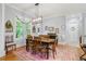 Bright dining room with a modern light fixture and view of the backyard through shuttered windows at 11 York Trce, Cartersville, GA 30121