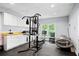 Bright exercise room with modern equipment, storage cabinets, and natural light, ideal for home workouts at 11 York Trce, Cartersville, GA 30121