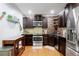 Modern kitchen with stainless steel appliances, dark wood cabinets, and stylish backsplash at 11 York Trce, Cartersville, GA 30121