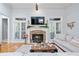 Comfortable living room featuring a stone fireplace, plantation shutters, and hardwood floors at 11 York Trce, Cartersville, GA 30121