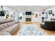 Bright living room with stone fireplace, hardwood floors, and comfortable seating arrangements at 11 York Trce, Cartersville, GA 30121