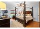 Comfortable bedroom with canopy bed, hardwood floors, and natural light at 11 York Trce, Cartersville, GA 30121