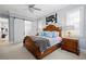 Comfortable main bedroom boasts a ceiling fan, natural light, sliding barn door, and neutral walls and carpet at 11 York Trce, Cartersville, GA 30121