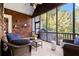 Cozy screened porch with cedar shake details, ceiling fan, and comfortable wicker furniture at 11 York Trce, Cartersville, GA 30121