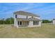 Two-story home with a covered patio and many windows, surrounded by a lush green lawn at 165 Haverling Pass, Hampton, GA 30228
