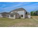 Spacious backyard featuring a well-manicured lawn and beautiful two-story home with ample windows at 165 Haverling Pass, Hampton, GA 30228