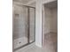 Modern bathroom featuring a glass-enclosed shower with gray tile surround and a walk-in closet at 165 Haverling Pass, Hampton, GA 30228