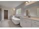 Bathroom with freestanding tub, double vanity, and gray tile floor at 165 Haverling Pass, Hampton, GA 30228