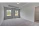 Spacious bedroom with neutral walls, plush carpet, and a view of nature outside at 165 Haverling Pass, Hampton, GA 30228