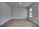 Bright and airy bedroom with hardwood floors, neutral paint, and ample natural light from the windows at 165 Haverling Pass, Hampton, GA 30228