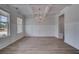Elegant dining room with a coffered ceiling, chandelier, hardwood floors, and wainscoting at 165 Haverling Pass, Hampton, GA 30228