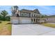 Spacious three-car garage and expansive driveway of this charming two-story home at 165 Haverling Pass, Hampton, GA 30228