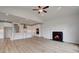 A living room with fireplace is open to a kitchen, has high ceilings and wood floors at 165 Haverling Pass, Hampton, GA 30228