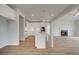 An open kitchen and living room features an island, white cabinetry, and a fireplace at 165 Haverling Pass, Hampton, GA 30228