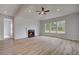 A open concept living room with fireplace, with wood look floors and neutral paint at 165 Haverling Pass, Hampton, GA 30228