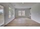 Bright, open living room features wood-look floors, and large windows at 165 Haverling Pass, Hampton, GA 30228
