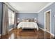 Large bedroom with hardwood floors, plantation shutters, and custom curtains at 2362 Saint Davids Nw Sq # 4, Kennesaw, GA 30152
