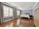 Bedroom with hardwood floors, three windows with shutters and custom curtains at 2362 Saint Davids Nw Sq # 4, Kennesaw, GA 30152