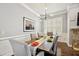 Elegant dining room with modern lighting, wainscoting and large windows at 2362 Saint Davids Nw Sq # 4, Kennesaw, GA 30152