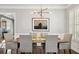 Formal dining room with stylish chandelier, wainscoting, hardwood floors and plantation shutters at 2362 Saint Davids Nw Sq # 4, Kennesaw, GA 30152