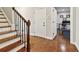Welcoming entryway featuring hardwood floors, staircase, and access to home office at 2362 Saint Davids Nw Sq # 4, Kennesaw, GA 30152
