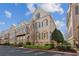 Beautiful townhome featuring brick construction, complemented by mature trees and manicured shrubs at 2362 Saint Davids Nw Sq # 4, Kennesaw, GA 30152