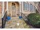 Charming front entrance with stone steps, wrought iron railings and decorative potted plants at 2362 Saint Davids Nw Sq # 4, Kennesaw, GA 30152
