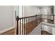 Upstairs hallway with hardwood flooring, wrought iron railing, and a view of the entry foyer at 2362 Saint Davids Nw Sq # 4, Kennesaw, GA 30152