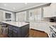 Kitchen with a large center island, white cabinetry, and hardwood floors at 2362 Saint Davids Nw Sq # 4, Kennesaw, GA 30152