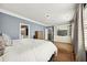 Bedroom with hardwood floors, custom curtains, and built-in shelving and cabinets at 2362 Saint Davids Nw Sq # 4, Kennesaw, GA 30152