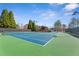 Community tennis courts with mature trees and clear blue sky at 2362 Saint Davids Nw Sq # 4, Kennesaw, GA 30152