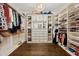 Custom walk-in closet with an abundance of storage, shelving, and clothing racks under a decorative chandelier at 2362 Saint Davids Nw Sq # 4, Kennesaw, GA 30152