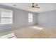 Spacious bedroom with neutral carpet, ceiling fan, and plenty of natural light from the windows at 315 Towergate Pl, Atlanta, GA 30350