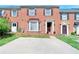 Charming brick townhome featuring a bay window, manicured lawn, and ample parking space at 315 Towergate Pl, Atlanta, GA 30350