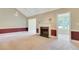 Cozy living room featuring a fireplace, neutral carpet, and natural light from a sunroom at 315 Towergate Pl, Atlanta, GA 30350
