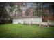 Exterior view of a home with a deck and a large grass backyard at 3893 Bonnie Se Ln, Atlanta, GA 30354