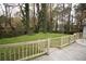 Fenced backyard with a grass lawn bordered by mature trees and lush foliage at 3893 Bonnie Se Ln, Atlanta, GA 30354