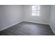 Bedroom featuring gray flooring, a window, and neutral paint at 3893 Bonnie Se Ln, Atlanta, GA 30354