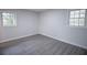 Bright bedroom featuring gray wood flooring, neutral walls and two windows providing natural light at 3893 Bonnie Se Ln, Atlanta, GA 30354