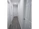 Hallway features multiple white paneled doors, neutral walls, and grey vinyl flooring at 3893 Bonnie Se Ln, Atlanta, GA 30354