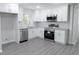 Bright kitchen features stainless steel appliances, granite countertops, and updated cabinets at 3893 Bonnie Se Ln, Atlanta, GA 30354