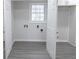 A laundry room featuring vinyl flooring, neutral walls, and closet storage at 3893 Bonnie Se Ln, Atlanta, GA 30354