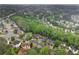 A vibrant, green neighborhood offers a mix of charming homes along winding streets, shaded by mature trees at 2118 Township Dr, Woodstock, GA 30189