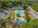 Community clubhouse featuring a large pool, lounge area, and a blue water slide at 2118 Township Dr, Woodstock, GA 30189
