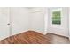 Bright bedroom features wood-look floors, a closet, and a window at 2118 Township Dr, Woodstock, GA 30189