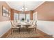 Bright dining room with hardwood floors, a chandelier, and a dining table set for six at 2118 Township Dr, Woodstock, GA 30189