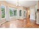 Dining room featuring hardwood floors, natural lighting from the window, and access to the backyard at 2118 Township Dr, Woodstock, GA 30189