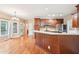 Open kitchen with stainless steel appliances, stone countertops, and cherry cabinets at 2118 Township Dr, Woodstock, GA 30189